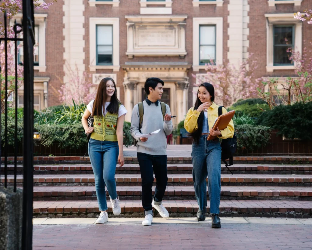 Three college students walking on campus