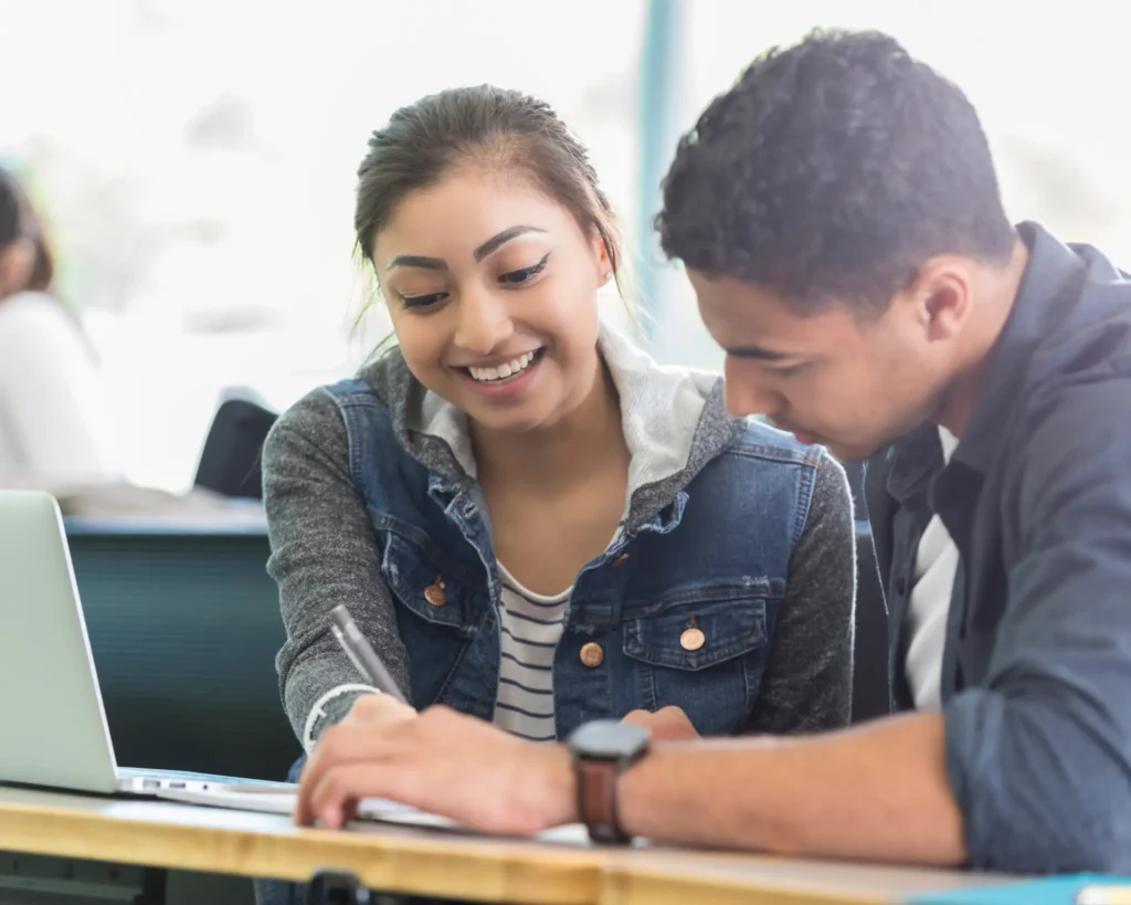 Two students studying together at a table