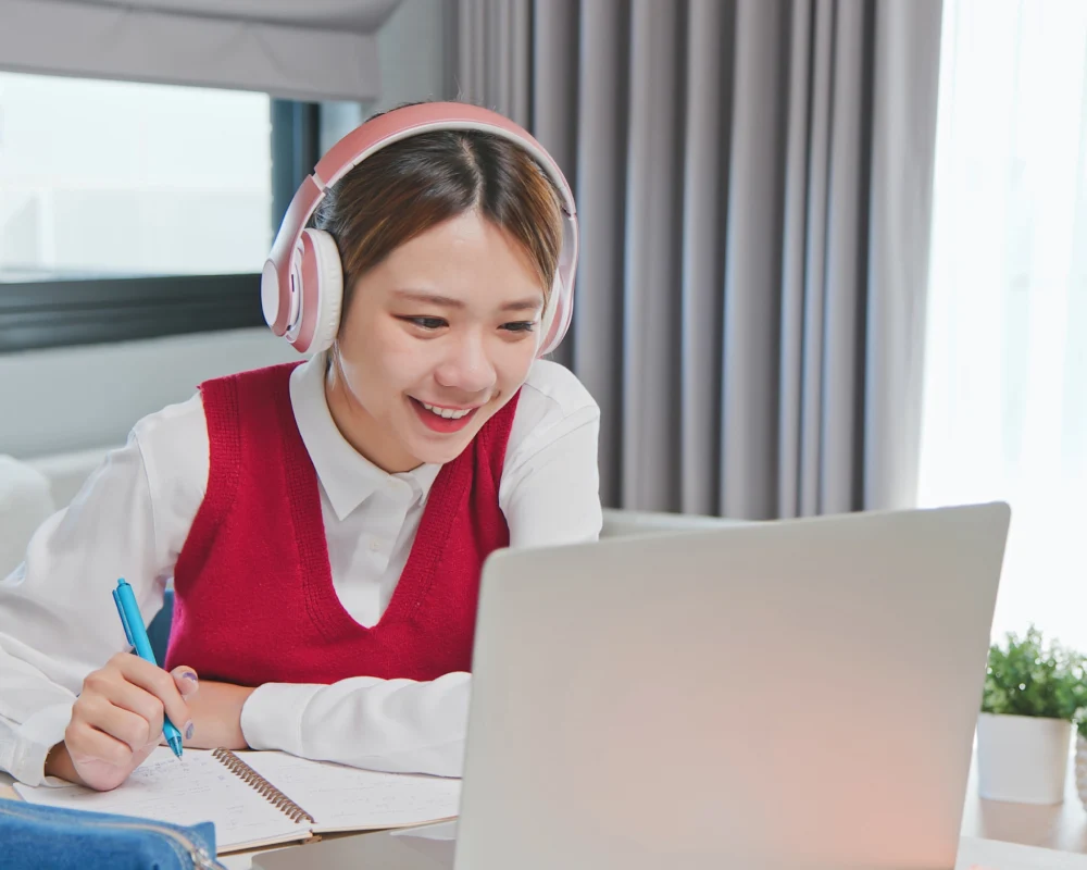 9th grade student smiling and holding books