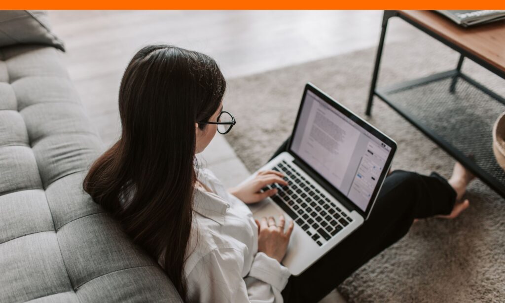 Student revising college essay with notes on computer draft for how long is a common app essay