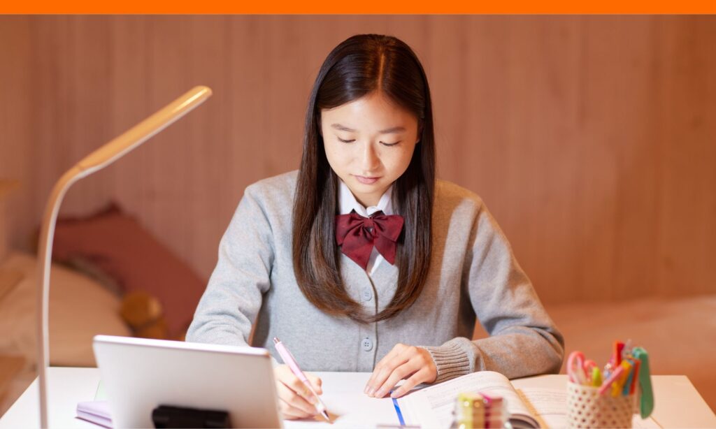 Teen girl studying at a desk to improve her chances of getting into college after being deferred