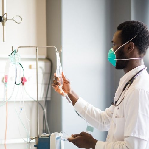 male doctor working wearing green mask