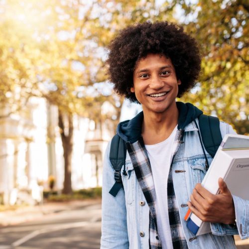 Student excited about MIT Acceptance rate, is holding his books